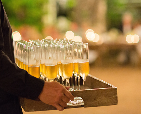 champagne passed on wooden tray