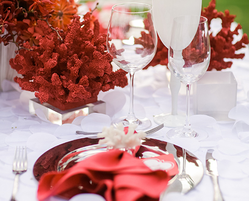 Colin Cowie Rehearsal Dinner Table Setup with Red Coral